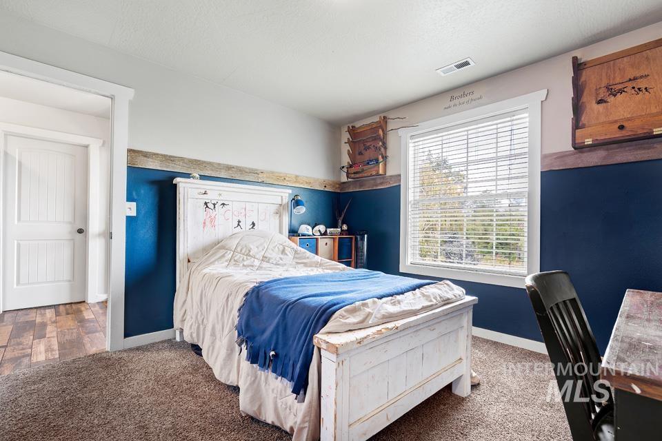 Bedroom featuring carpet floors and baseboards