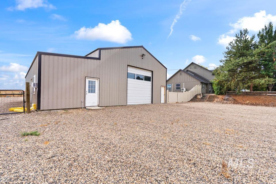 Detached garage with gravel driveway