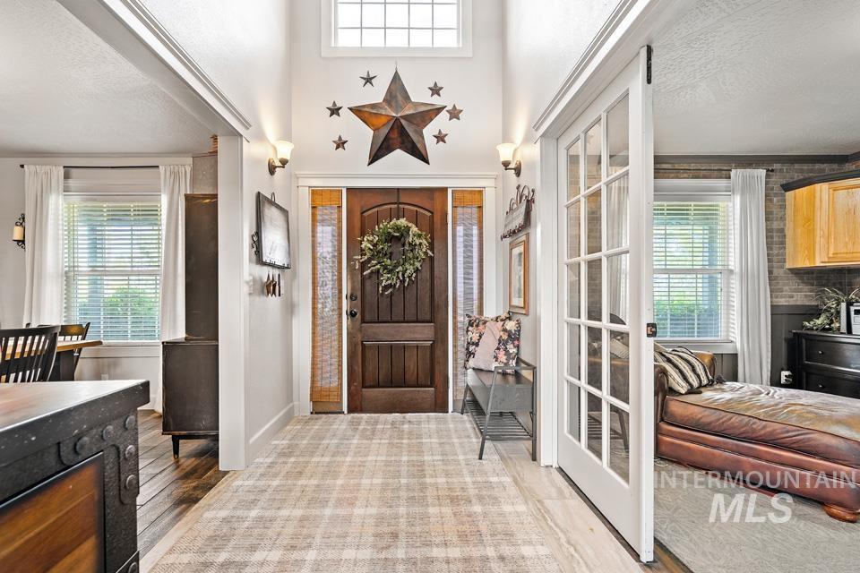 Entrance foyer featuring a textured ceiling and light wood-type flooring
