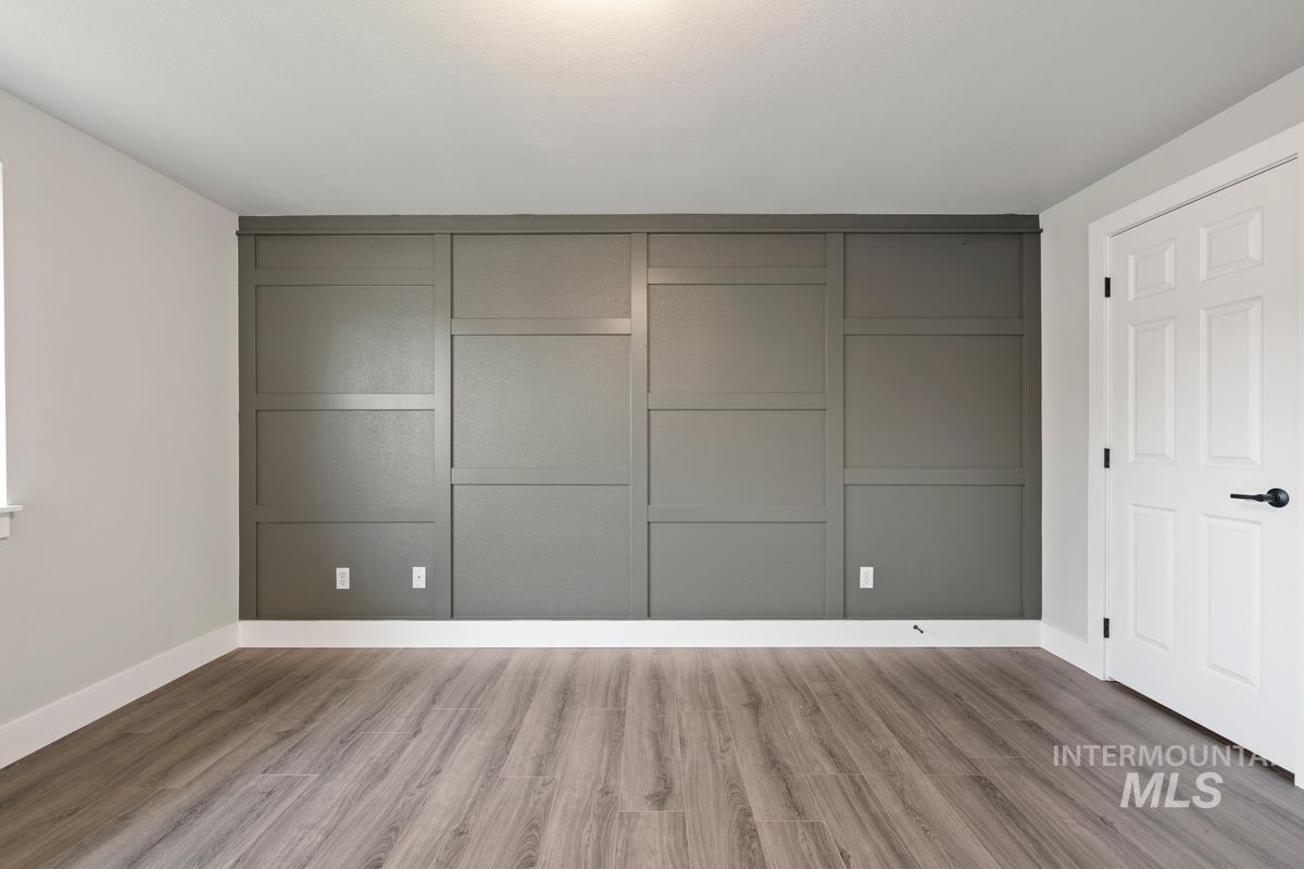 Unfurnished bedroom with a closet and wood finished floors