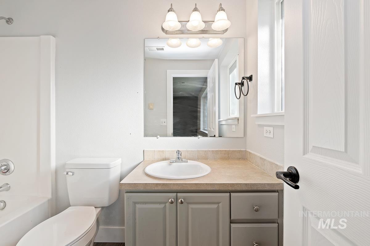 Bathroom featuring vanity and shower / bathtub combination
