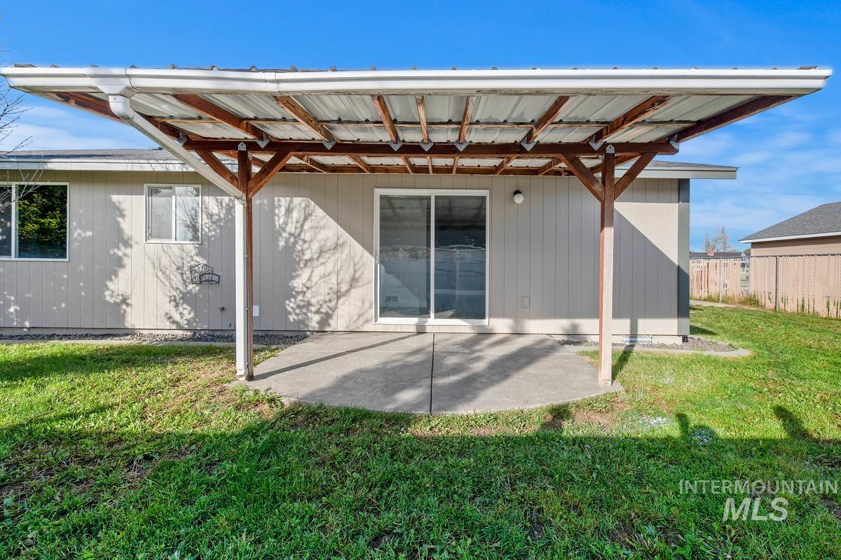 Back of property featuring a patio area and a yard