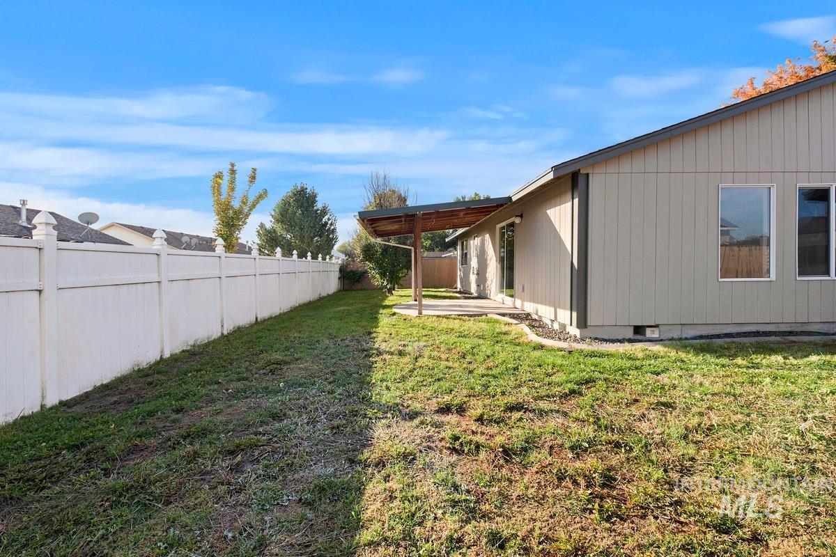 Fenced backyard with a patio