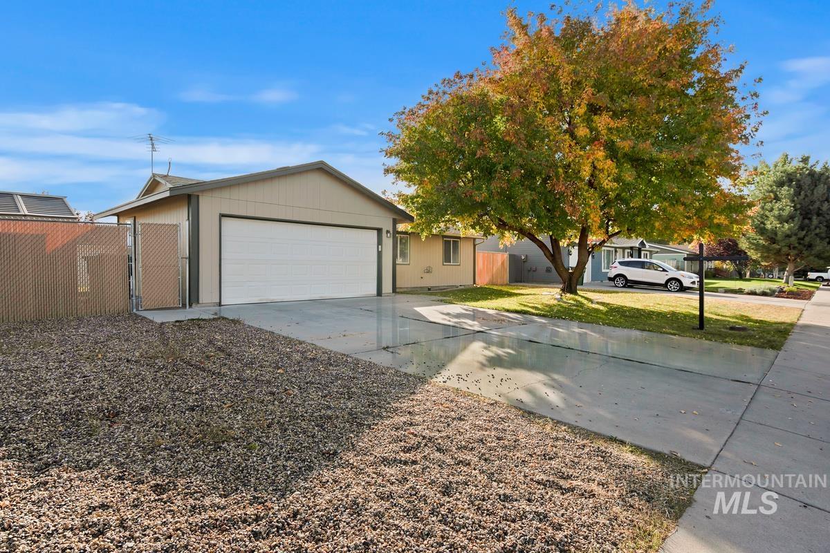 View of front of house featuring concrete driveway and an attached garage
