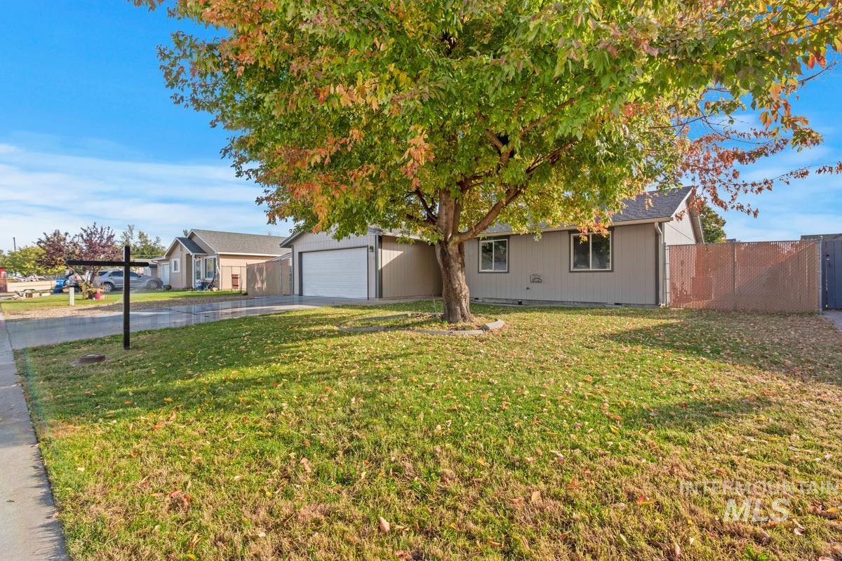 Ranch-style house featuring driveway and a garage