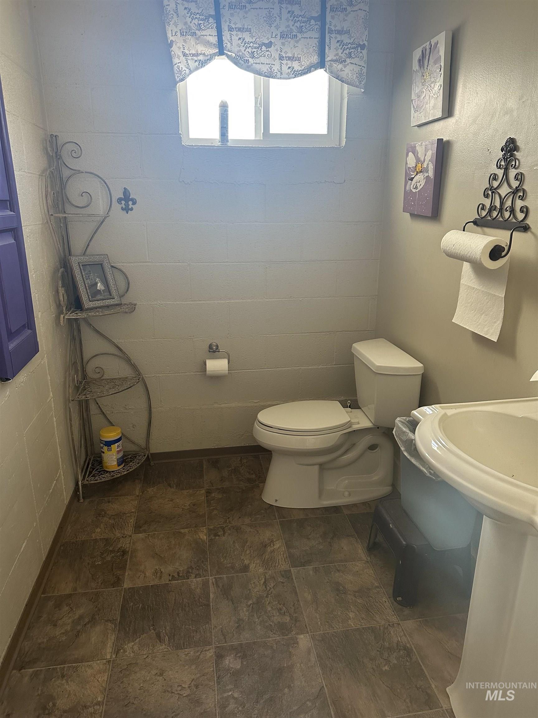 Half bath featuring toilet and a sink