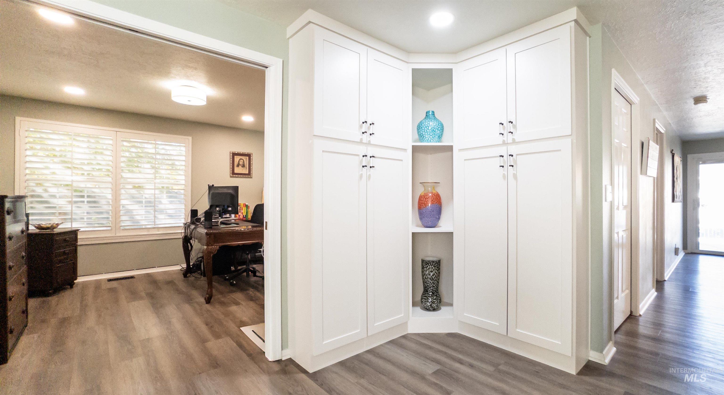 Mudroom with dark wood finished floors, a textured ceiling, and recessed lighting