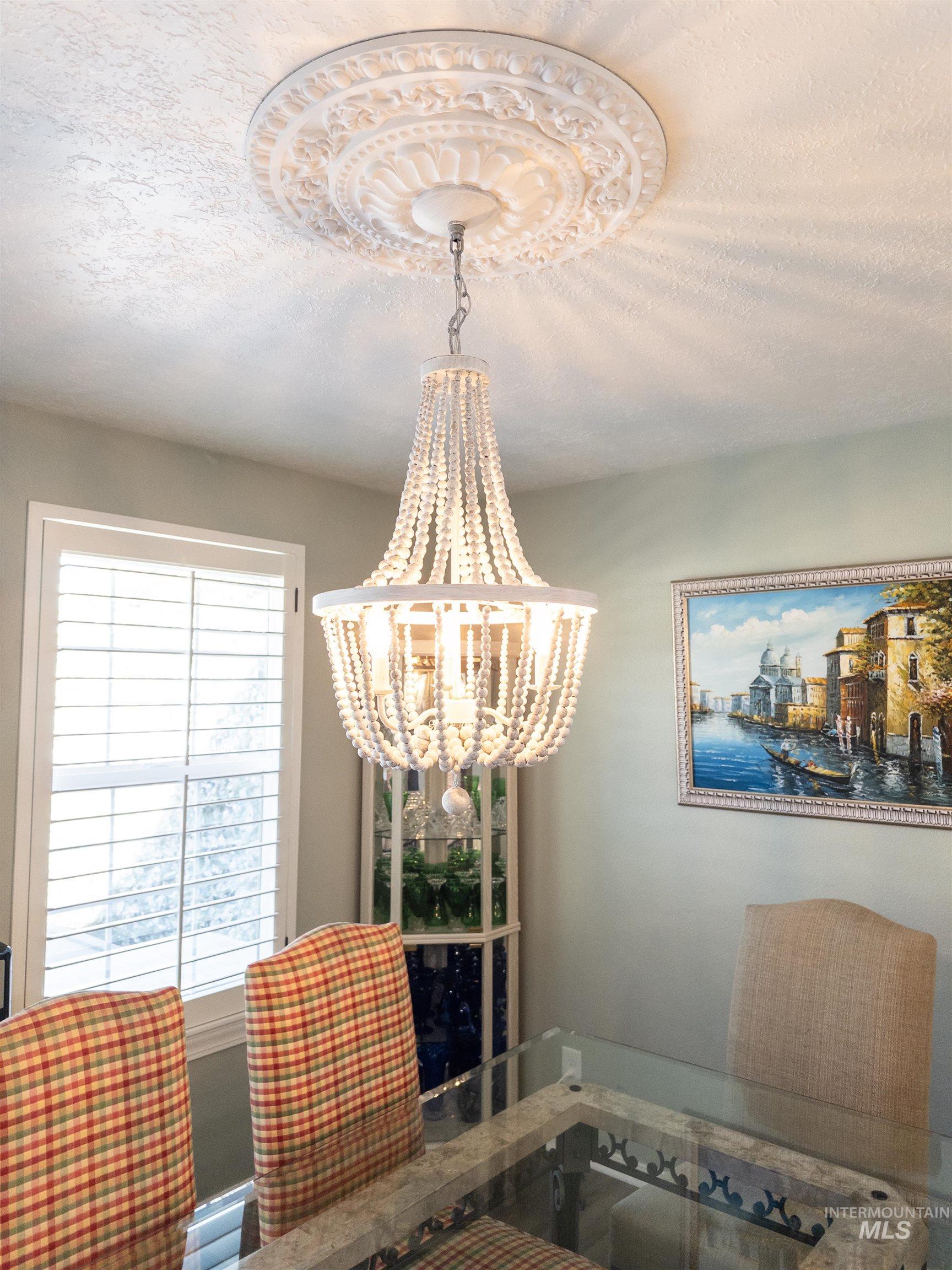 Dining area featuring a textured ceiling and a chandelier