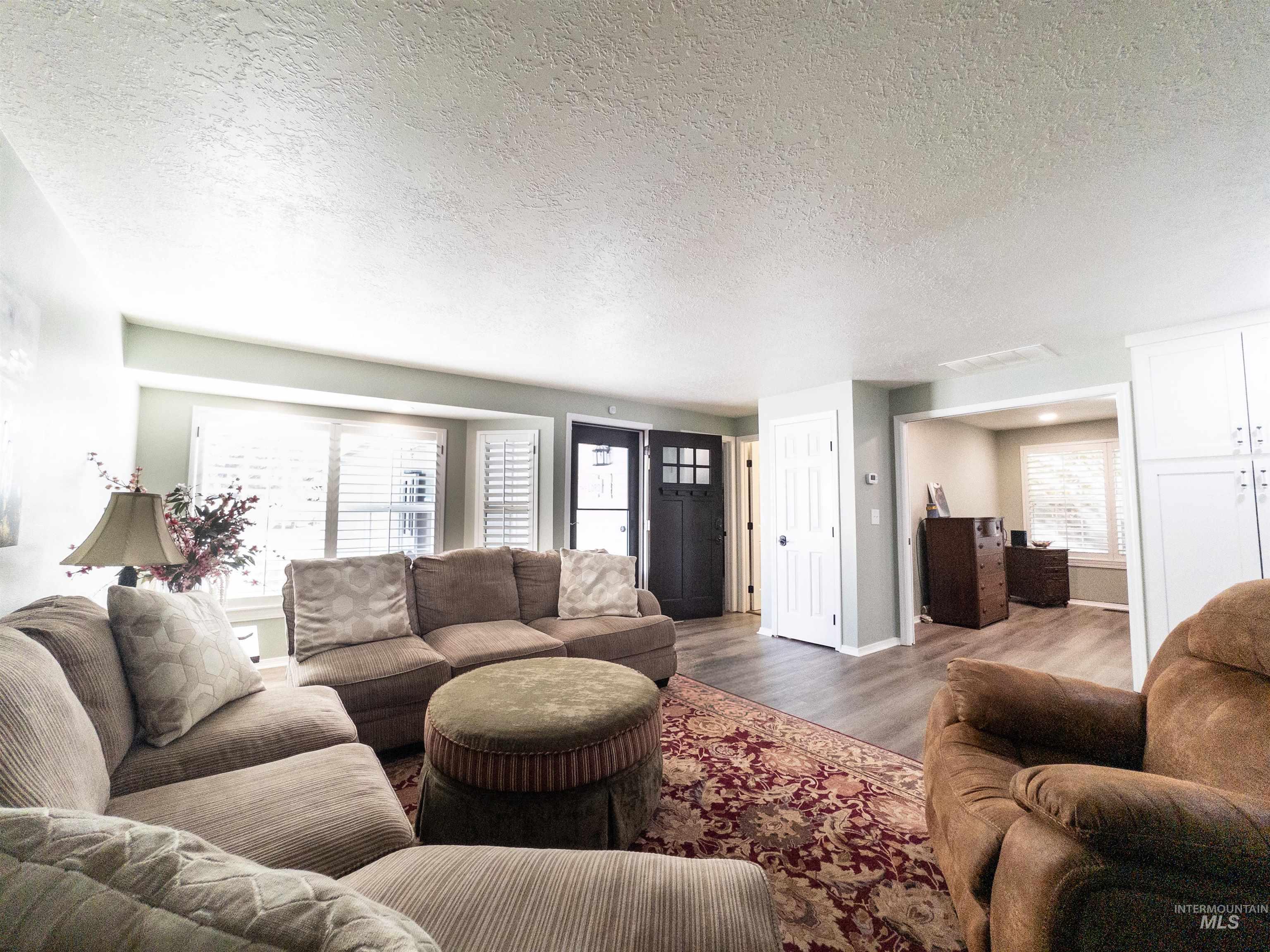 Living area featuring a textured ceiling and wood finished floors