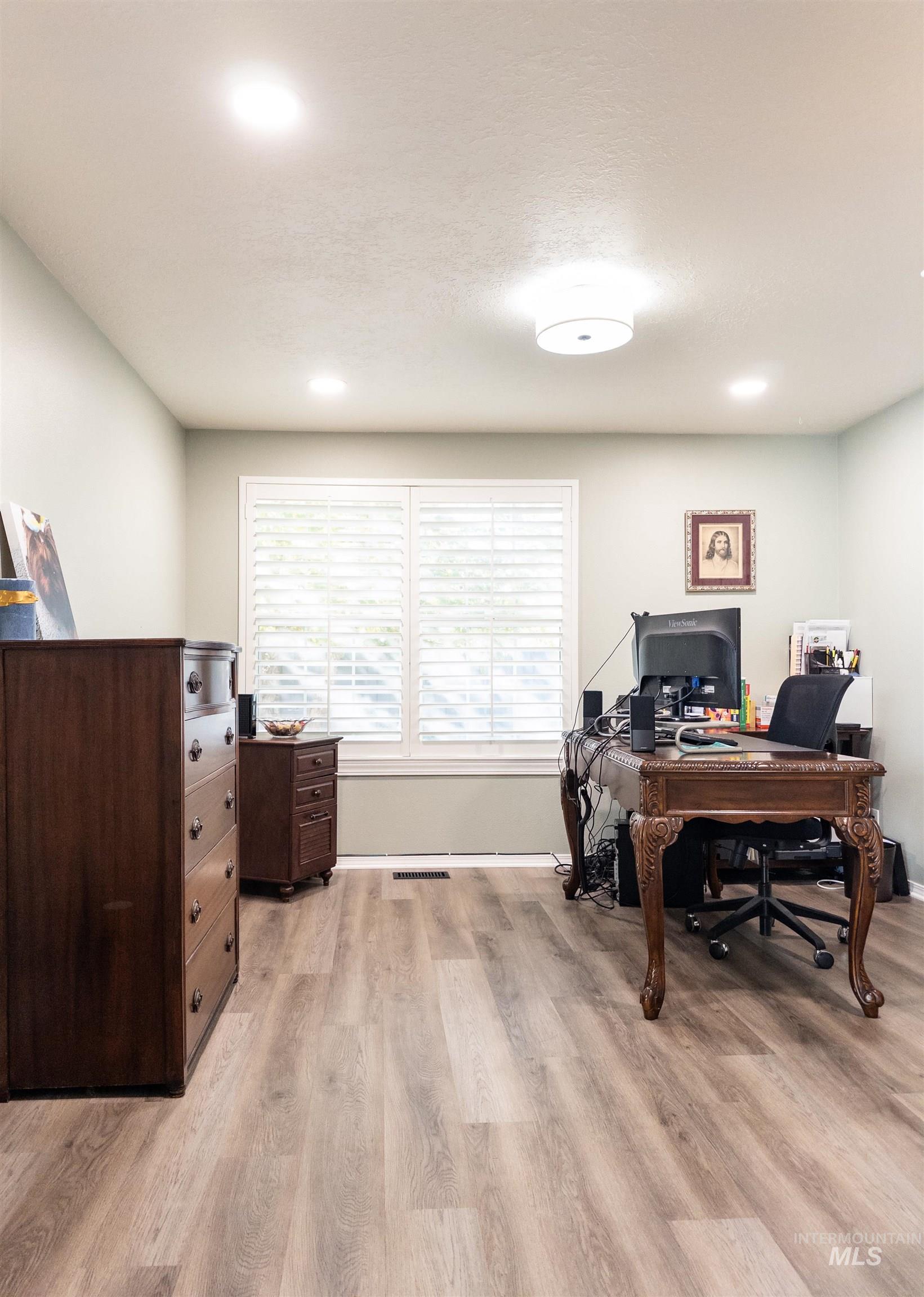Office space featuring light wood-type flooring