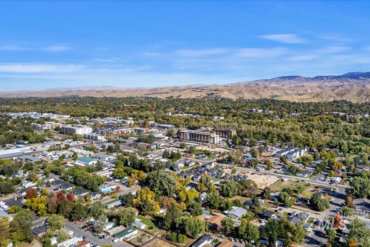 Aerial view of property's location with a mountain backdrop