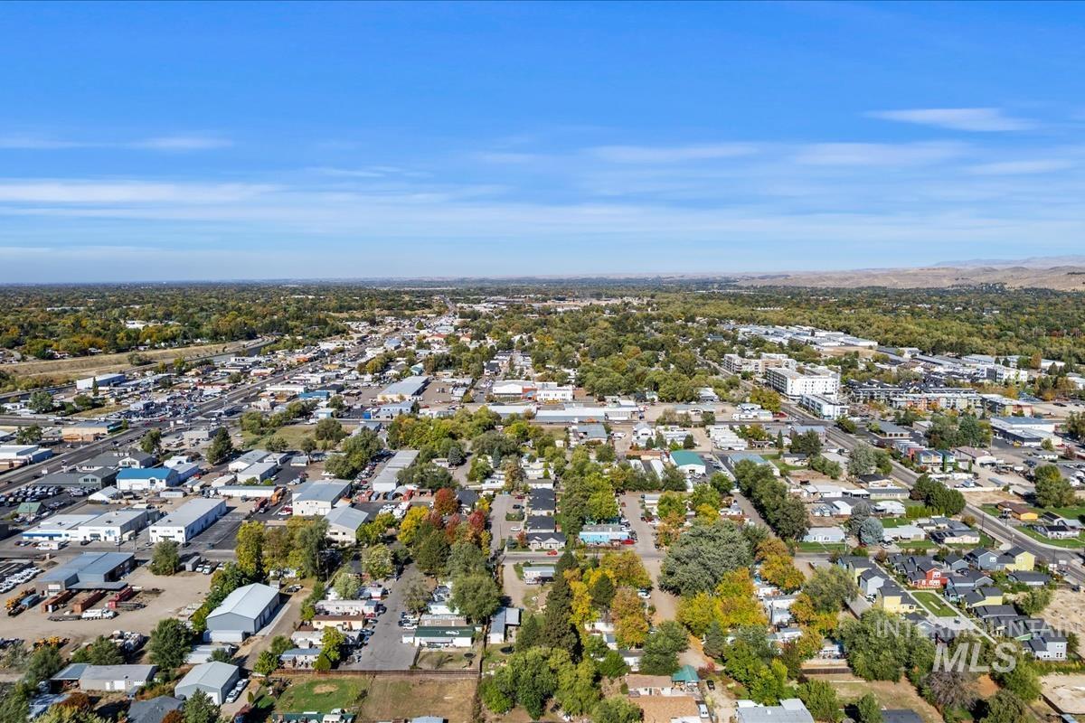 View of property location featuring a tree filled landscape