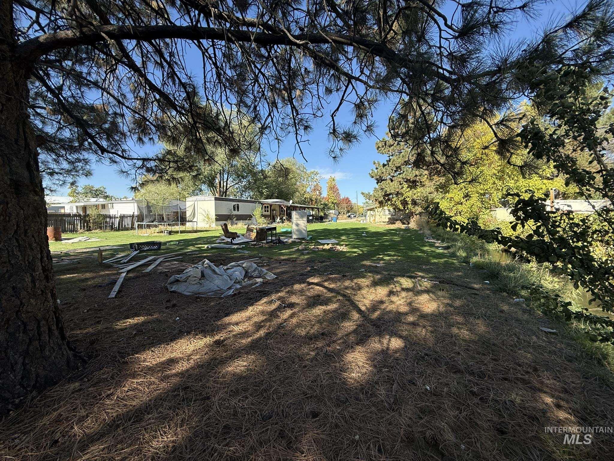 View of green lawn featuring a trampoline