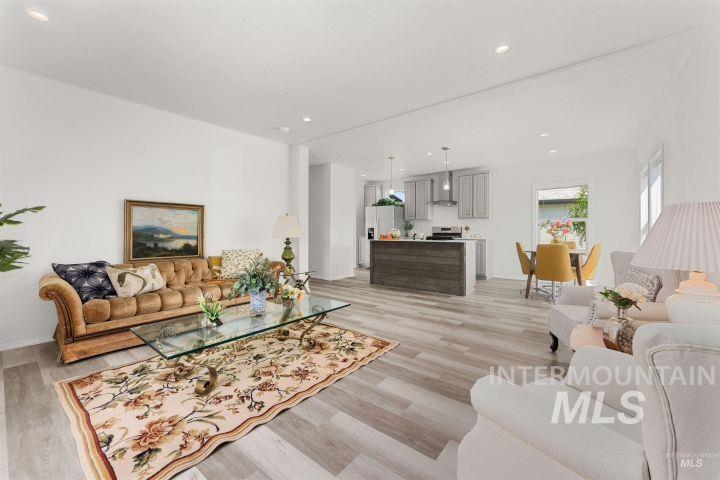 Living room with recessed lighting and light wood-type flooring