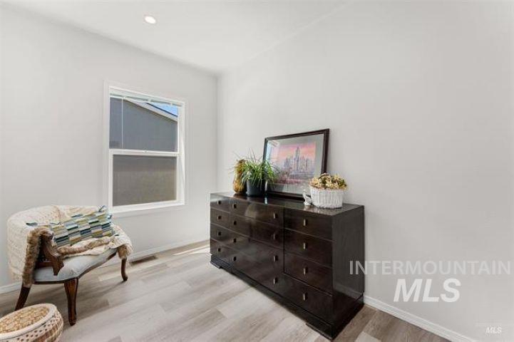 Sitting room featuring light wood finished floors and recessed lighting