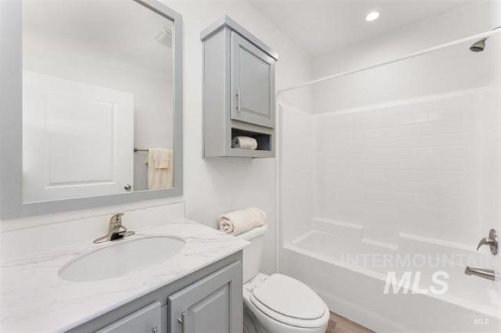 Full bathroom featuring tub / shower combination and vanity