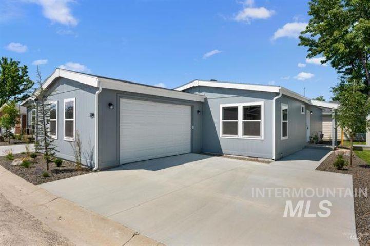 View of front of property with a garage and driveway