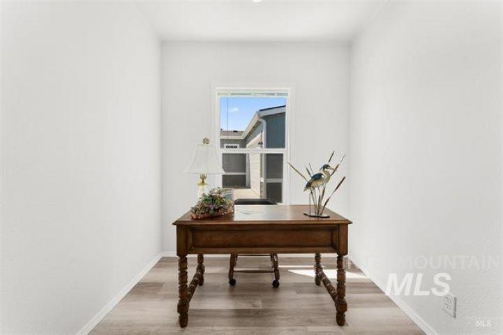 Office area featuring light wood-type flooring and baseboards