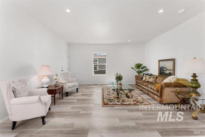 Living room featuring recessed lighting and light wood-type flooring