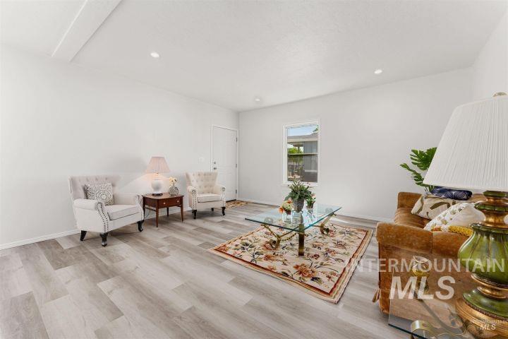 Living area featuring light wood-style flooring and recessed lighting