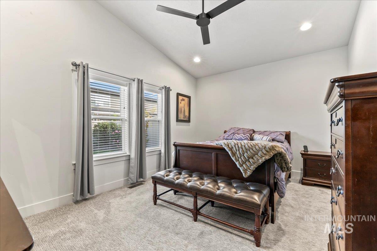 Bedroom featuring vaulted ceiling, light colored carpet, recessed lighting, and a ceiling fan