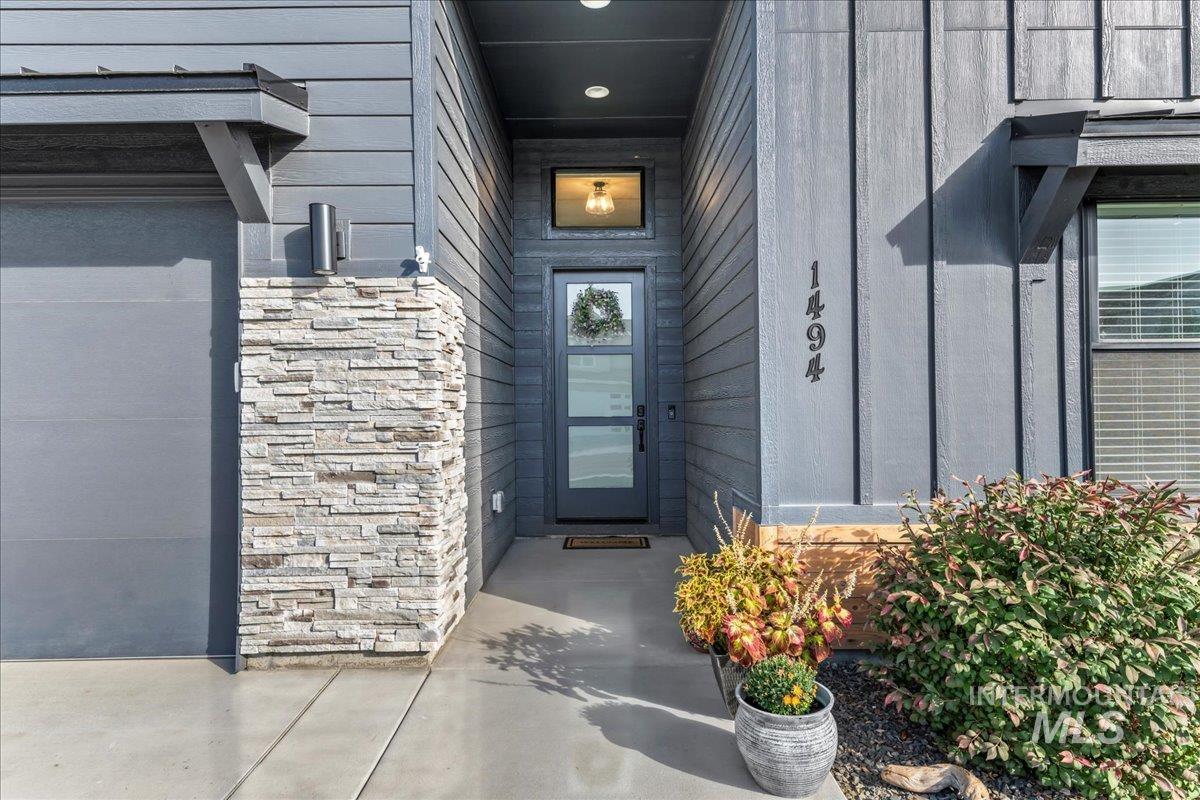 Doorway to property with stone siding
