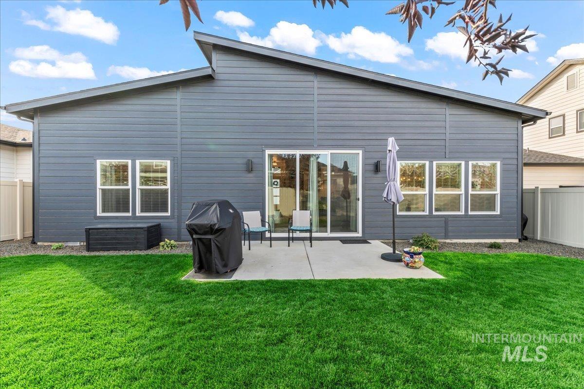 Rear view of property featuring a patio