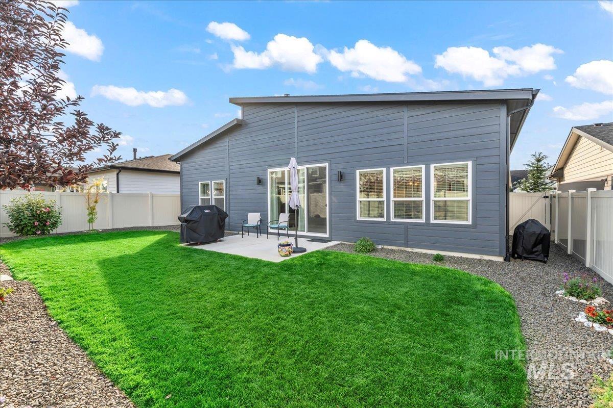Back of property with a fenced backyard and a patio