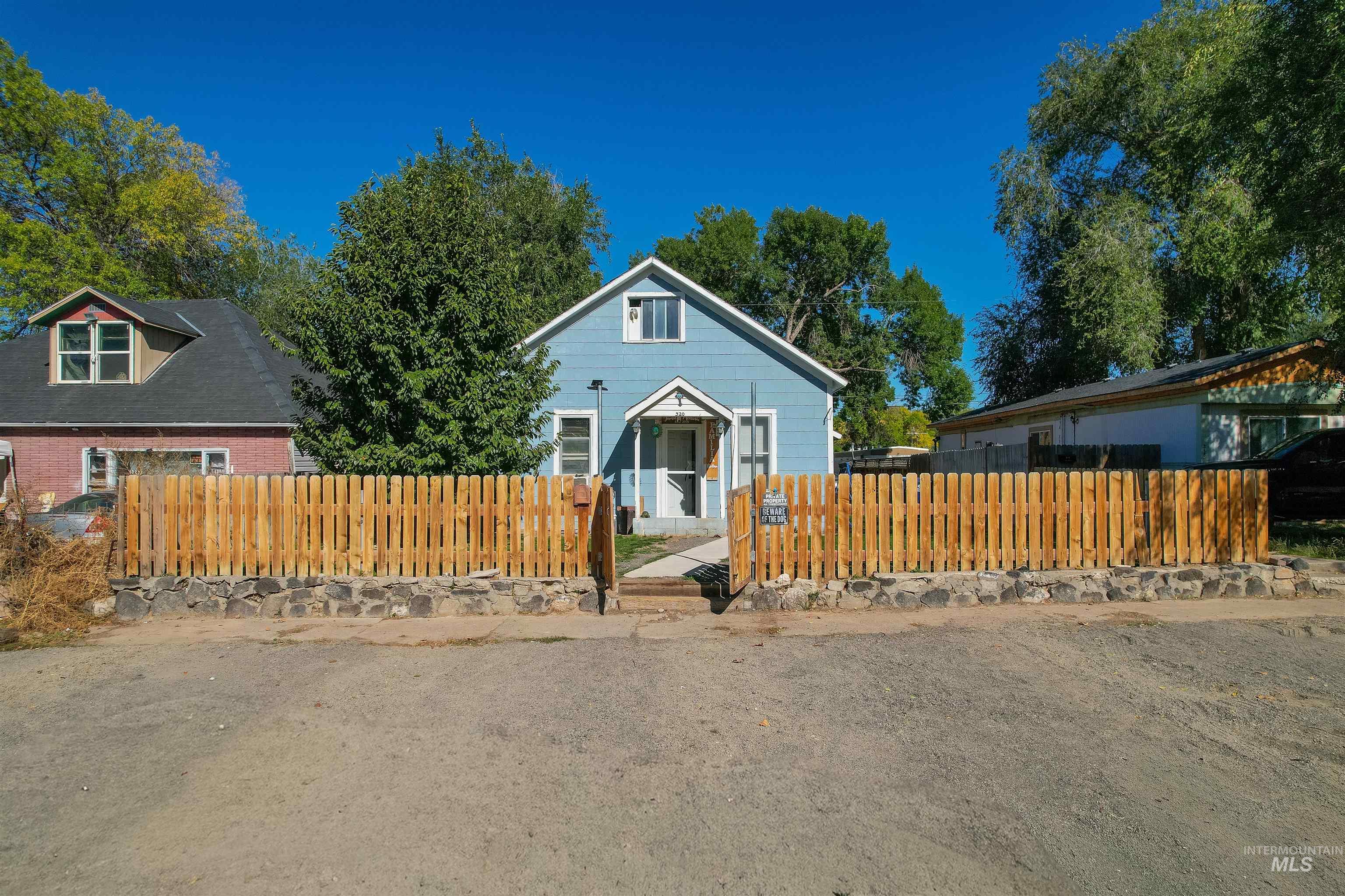 Bungalow-style house with a fenced front yard