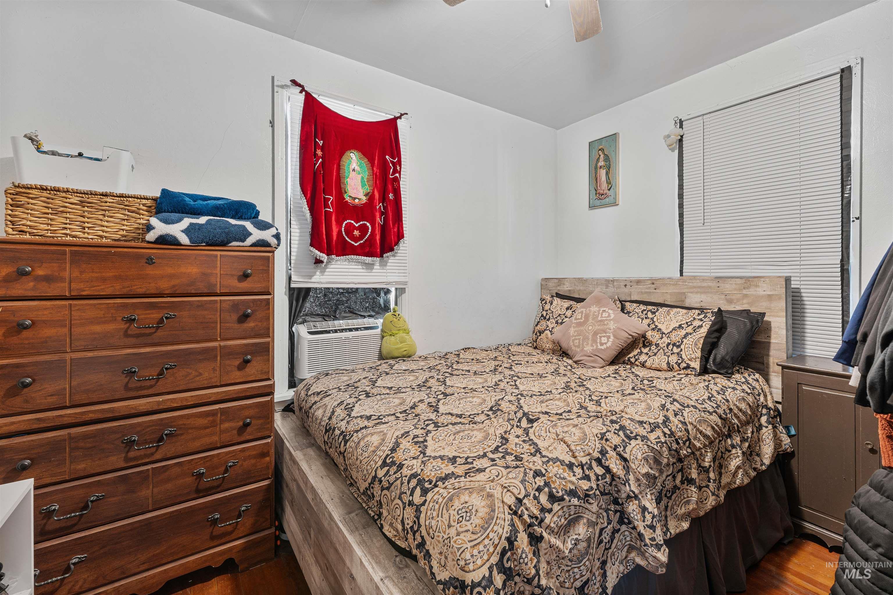 Bedroom with wood finished floors and a ceiling fan