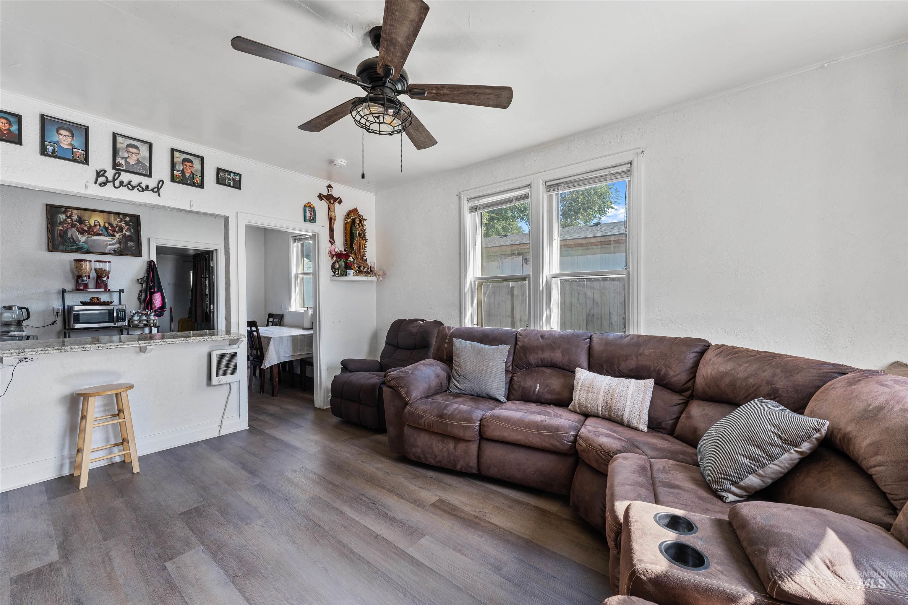 Living room with wood finished floors and ceiling fan