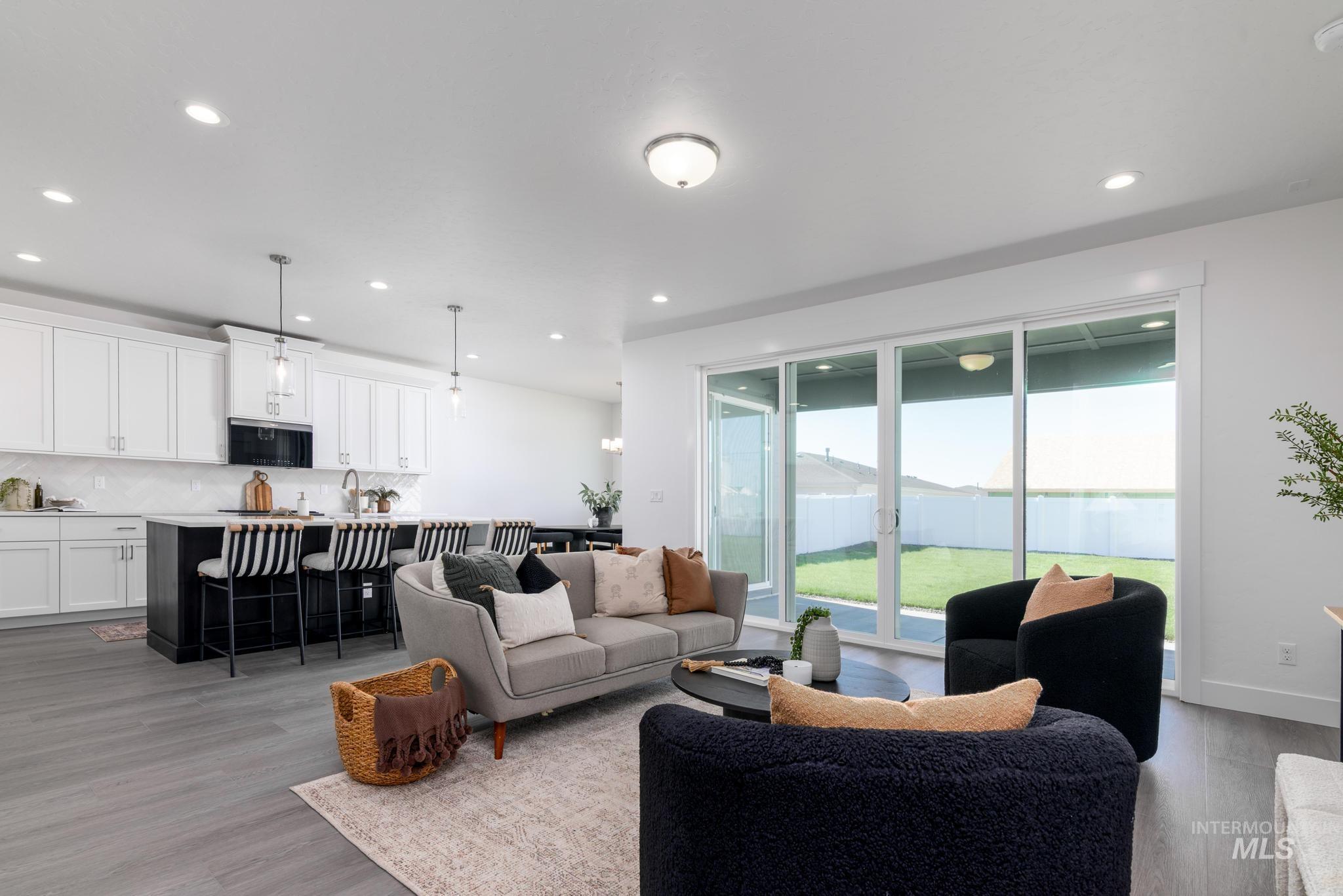 Living area featuring light wood-style floors and recessed lighting
