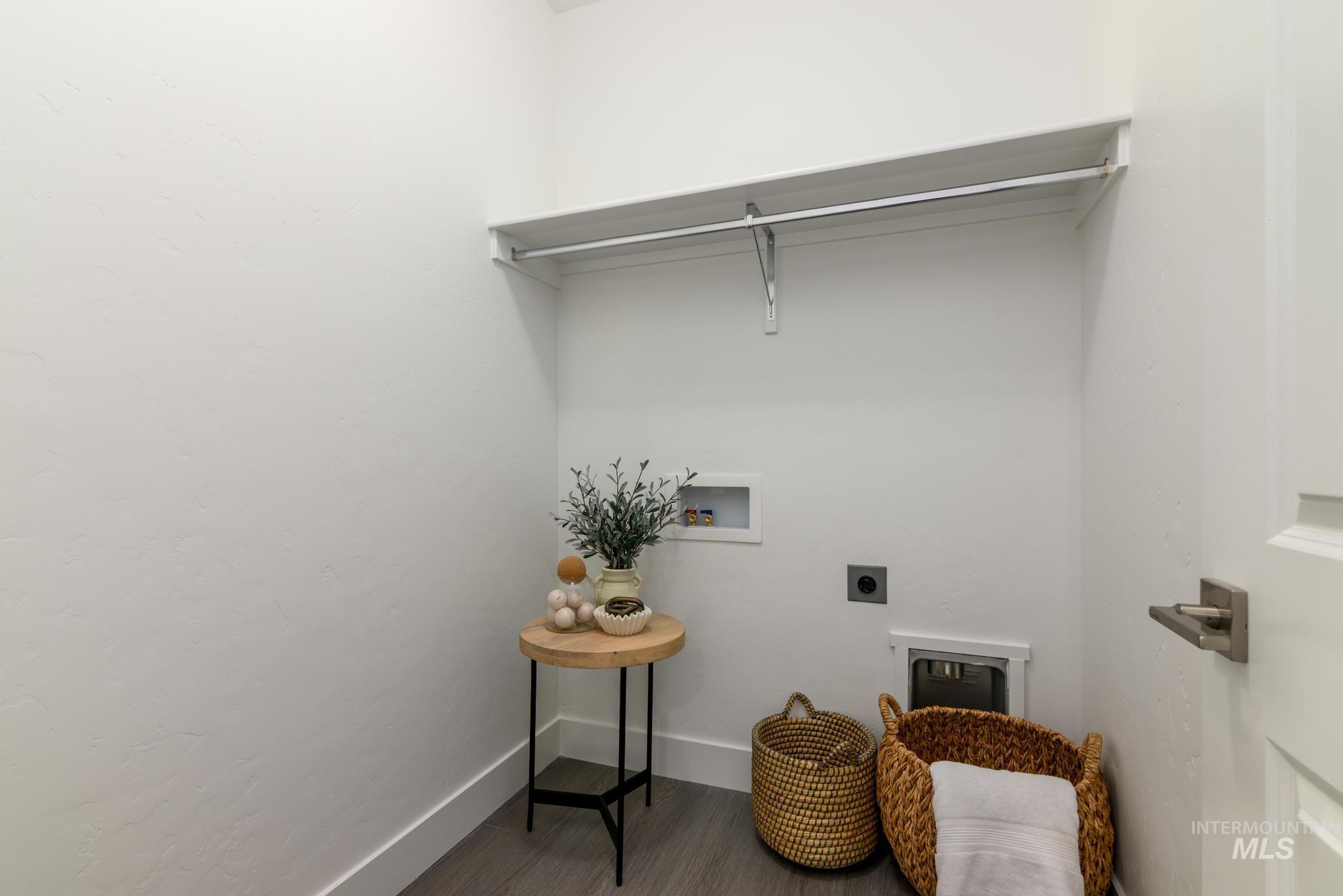 Laundry room with hookup for a washing machine, wood finished floors, and electric dryer hookup
