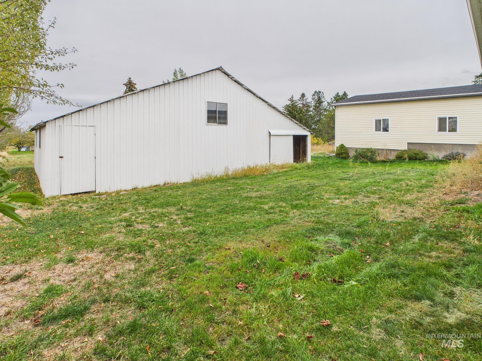 View of pole building with a lawn