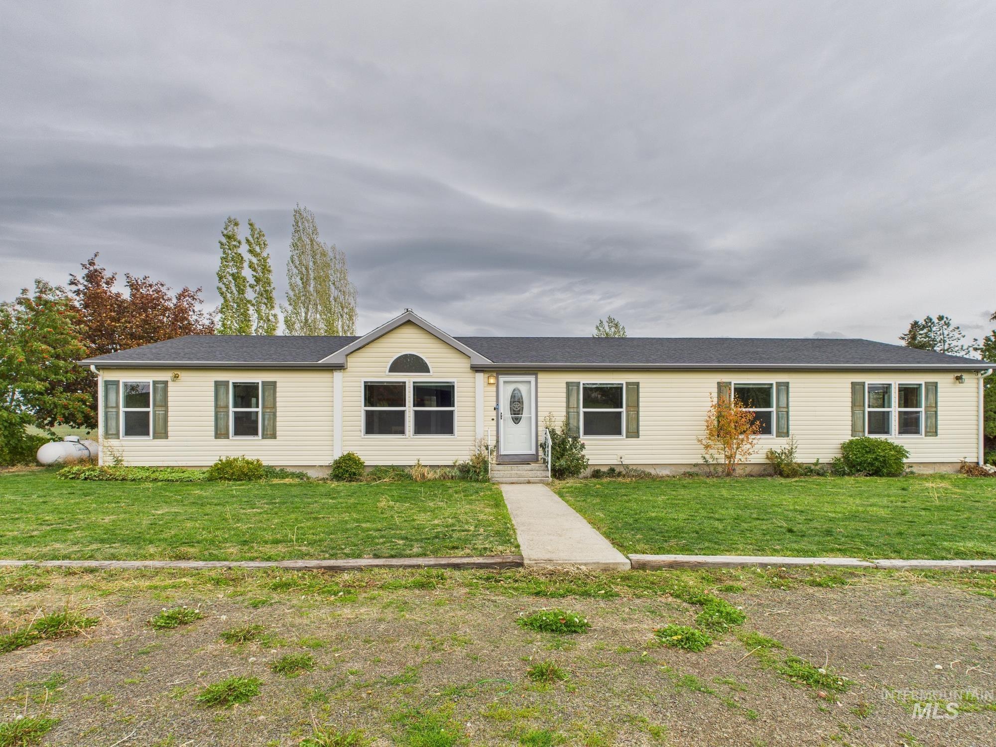 Single story home with a front lawn