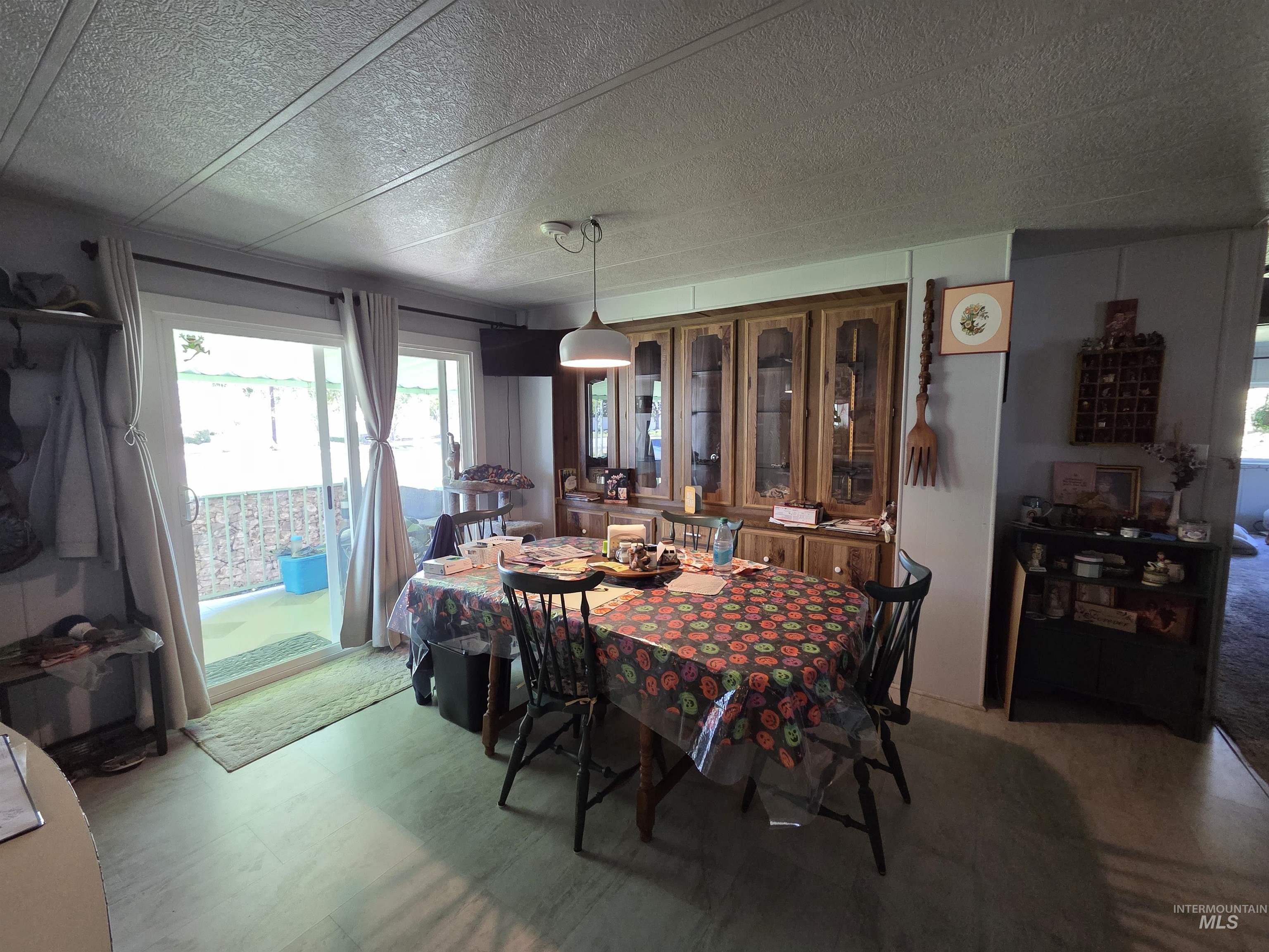 Dining space featuring healthy amount of natural light and a textured ceiling
