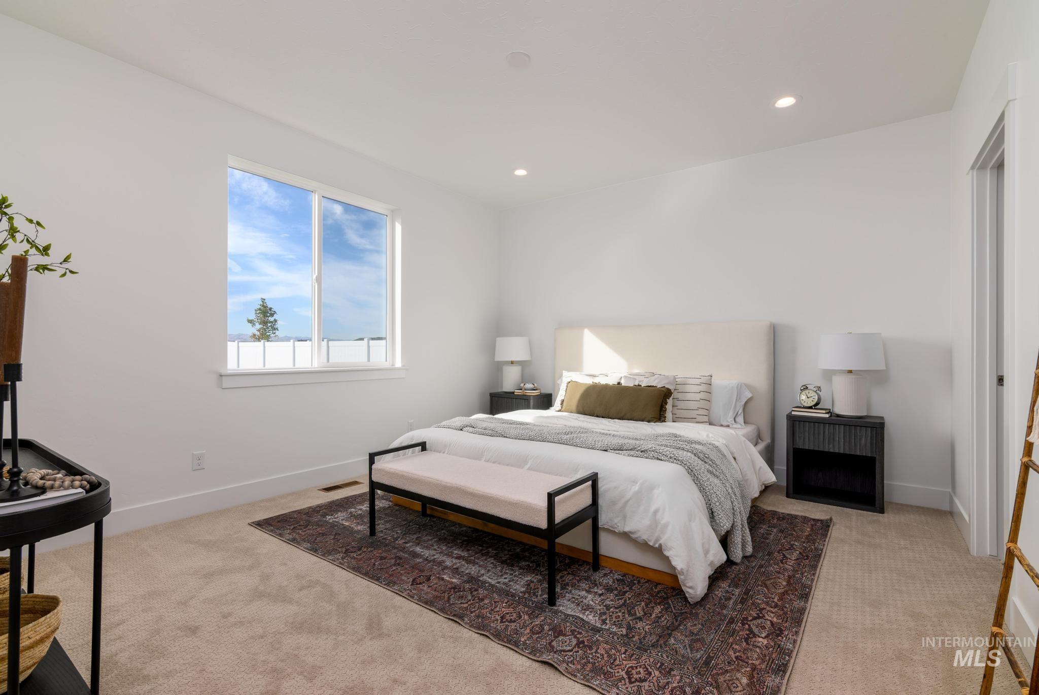 Bedroom featuring light colored carpet and recessed lighting