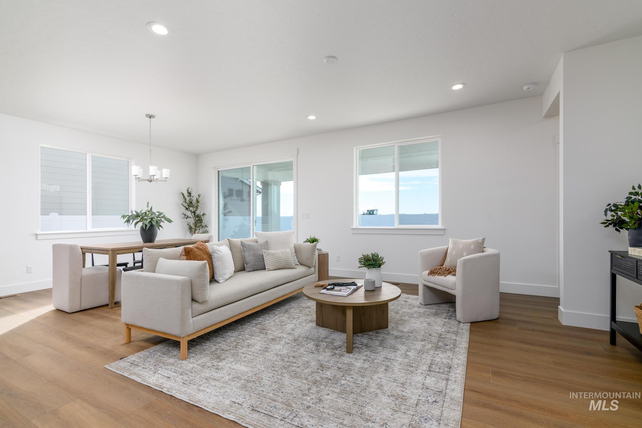 Living area featuring a chandelier, recessed lighting, and light wood-style floors