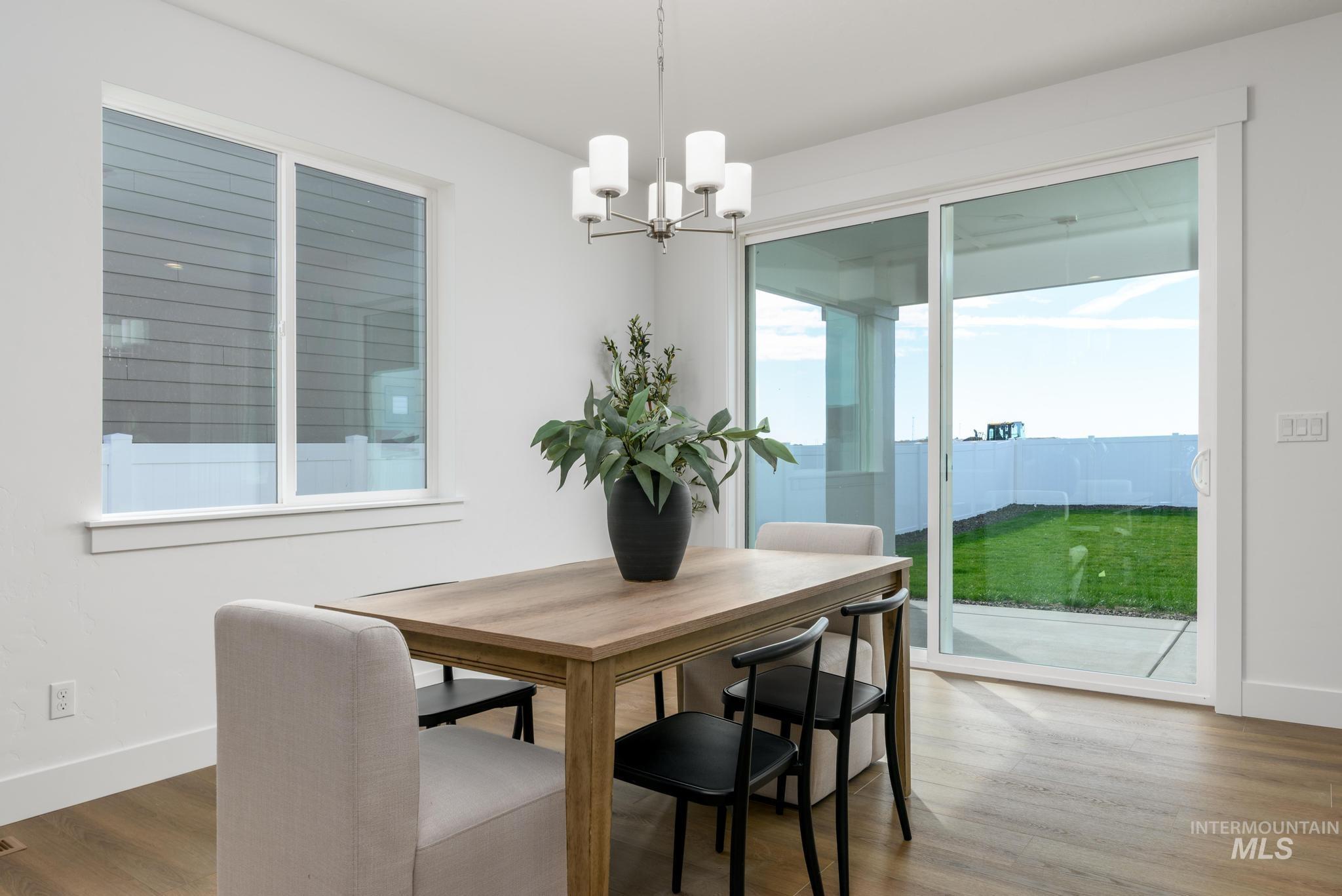 Dining room with wood finished floors and a chandelier