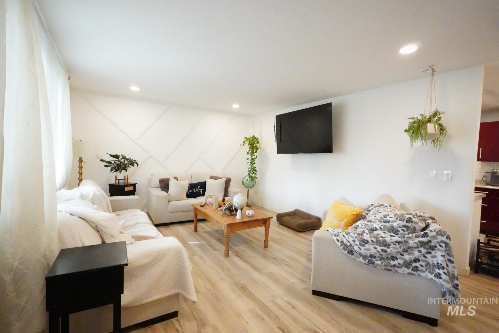 Living room with recessed lighting and light wood finished floors
