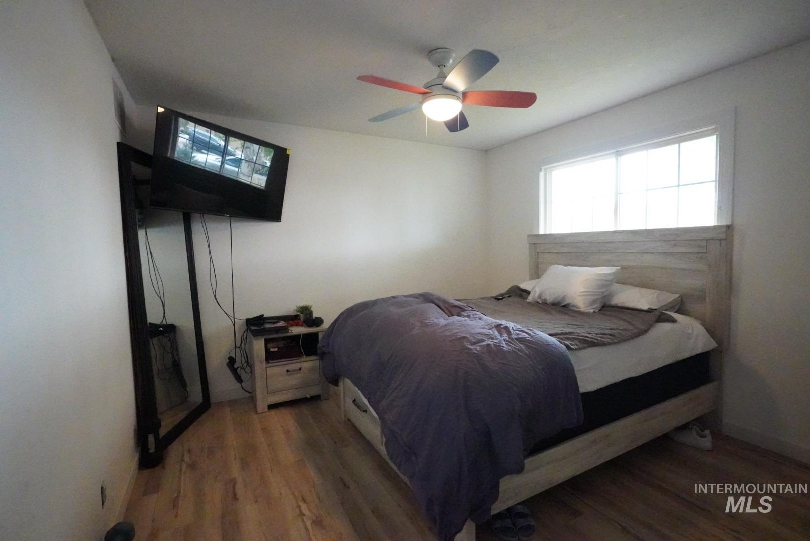 Bedroom featuring wood finished floors and ceiling fan