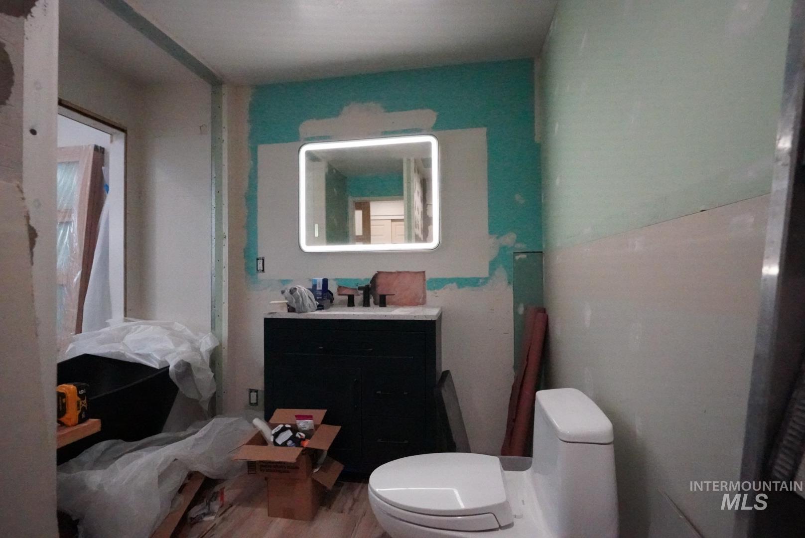 Bathroom with vanity and wood finished floors