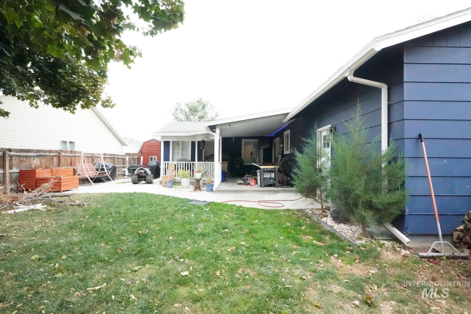 Back of property featuring a wooden deck and a patio area