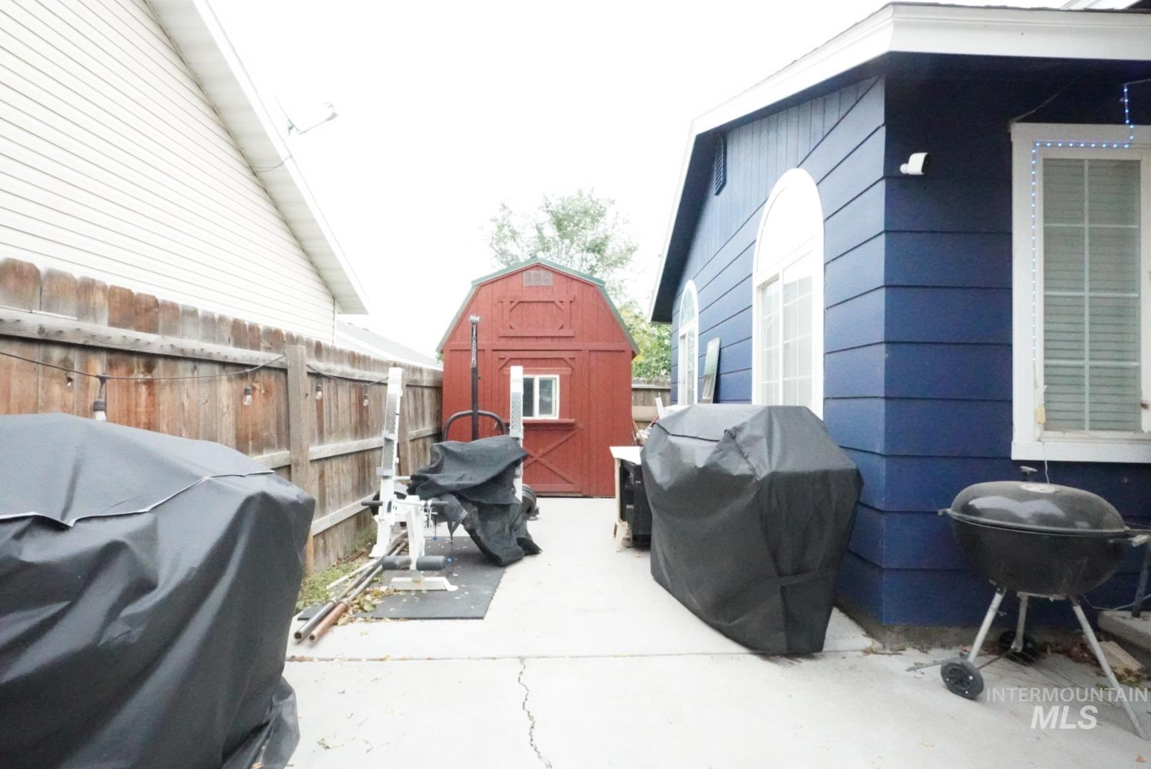 View of patio / terrace featuring area for grilling and a shed