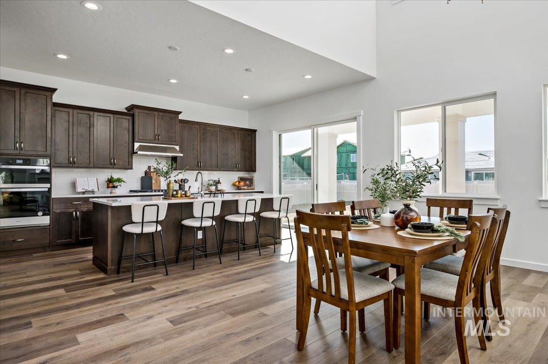 Dining area featuring recessed lighting and dark wood-style flooring