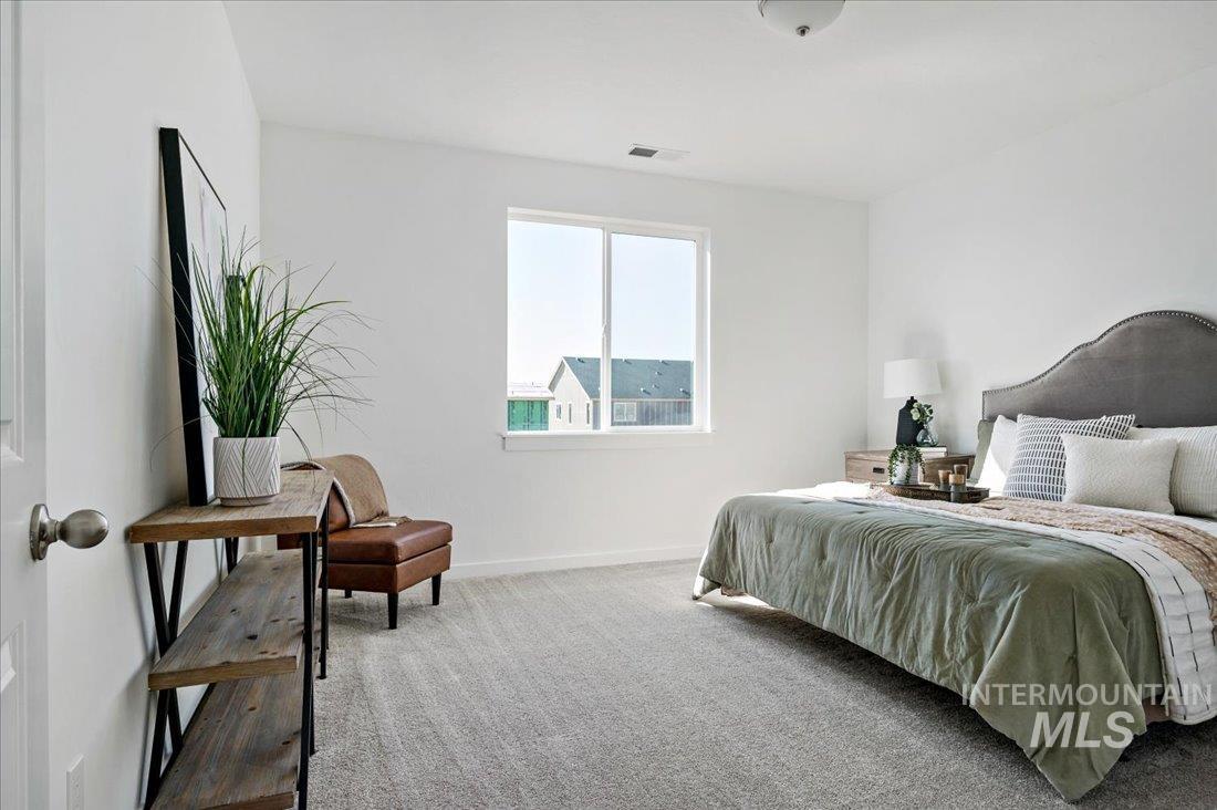 Bedroom with carpet flooring and baseboards