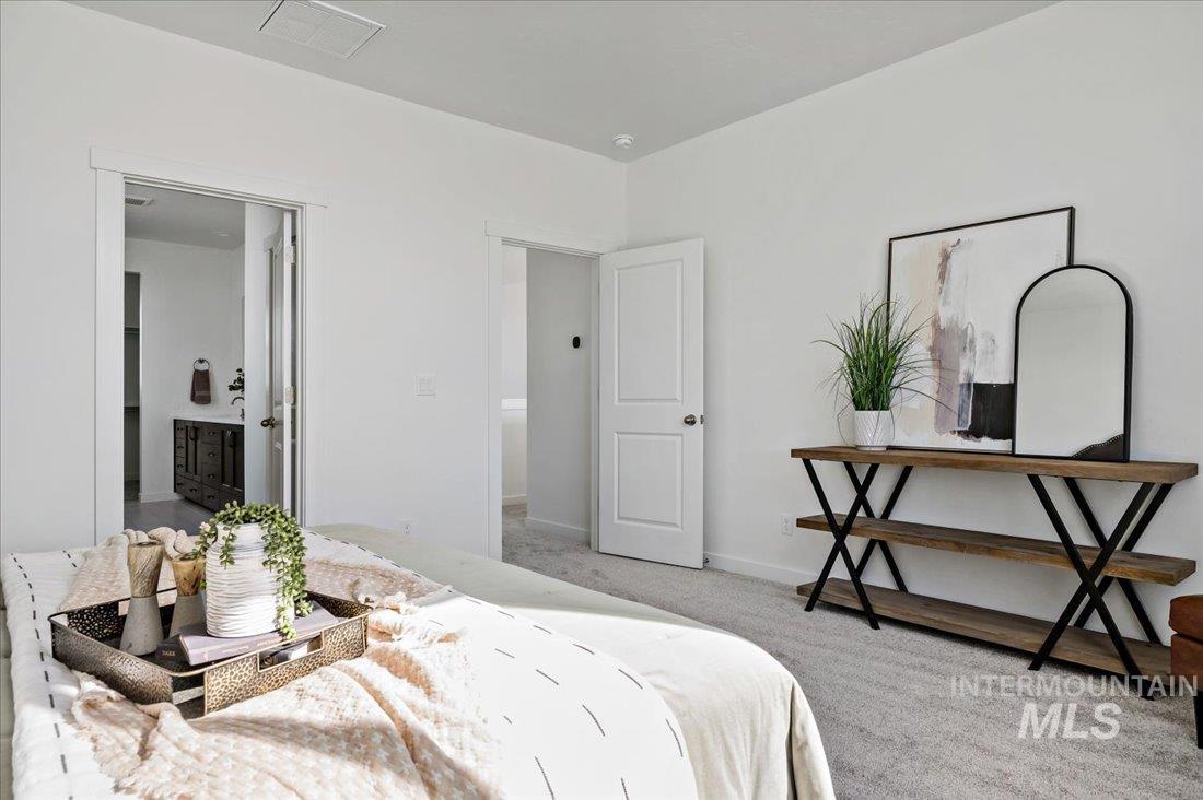 Bedroom with carpet and connected bathroom