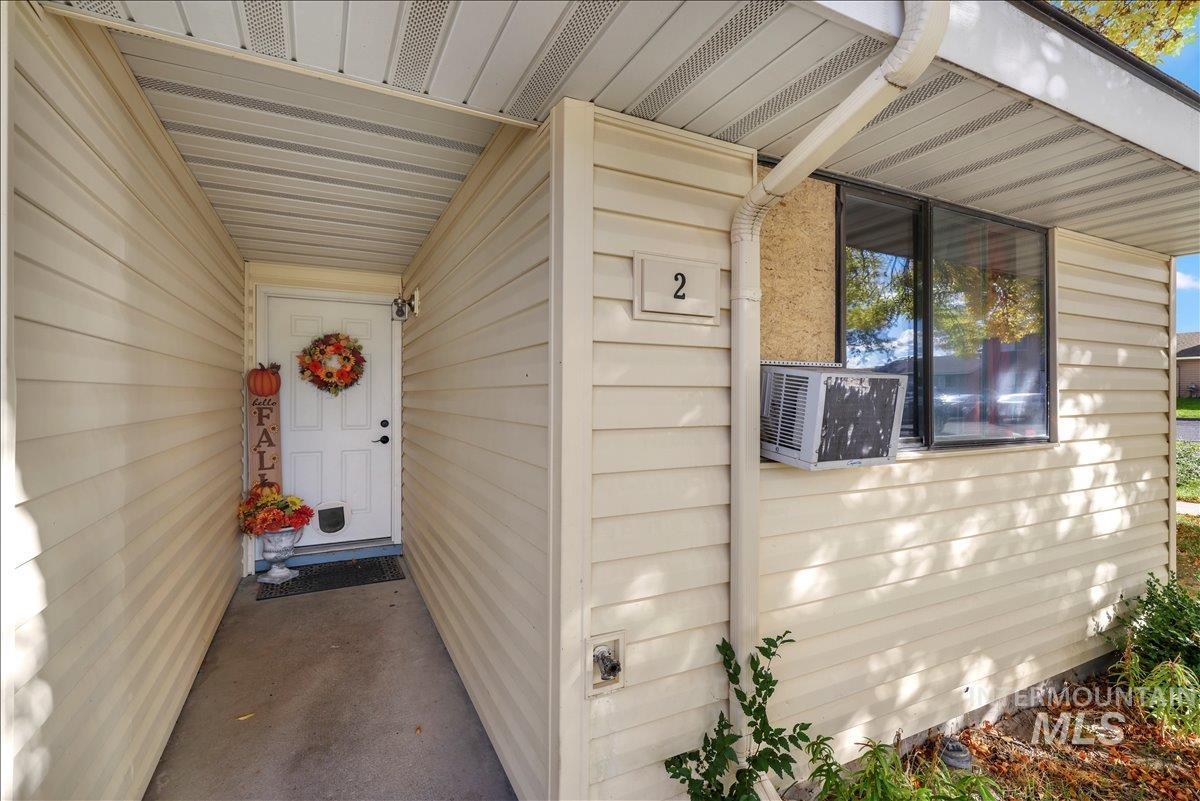 Doorway to property featuring cooling unit
