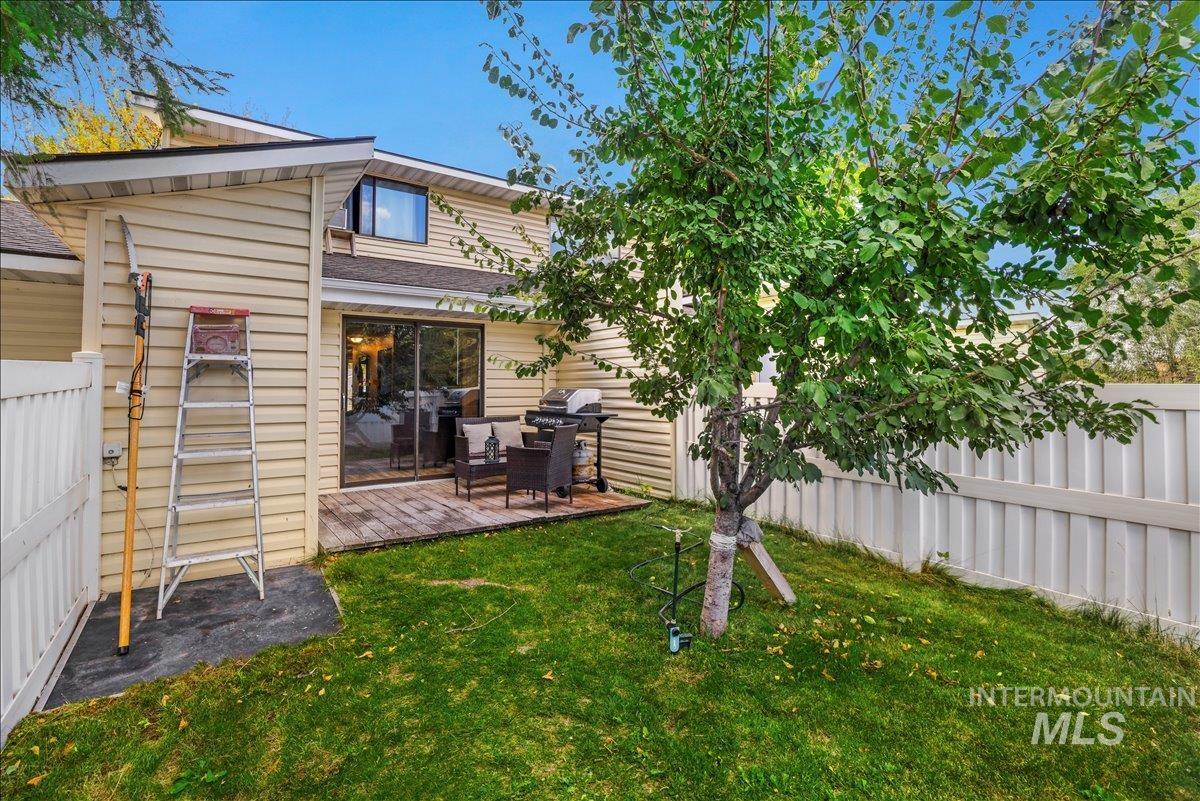 Fenced backyard featuring a deck