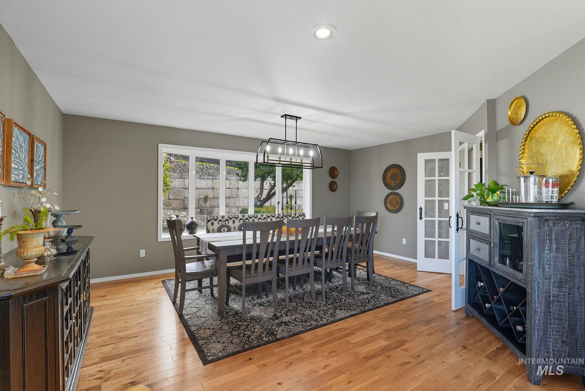 Dining room with light wood-type flooring and recessed lighting